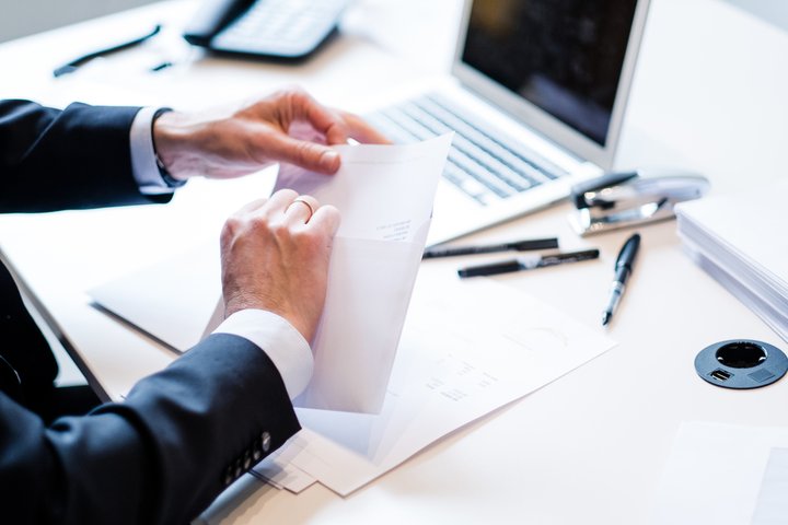 Man's hands in a suit with mail