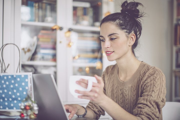 Woman with a mug of tea at a laptop 3