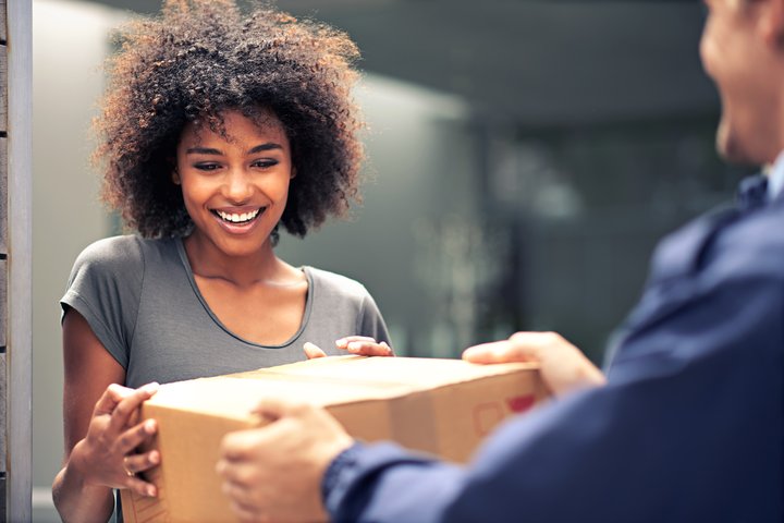 Happy woman receiving parcel