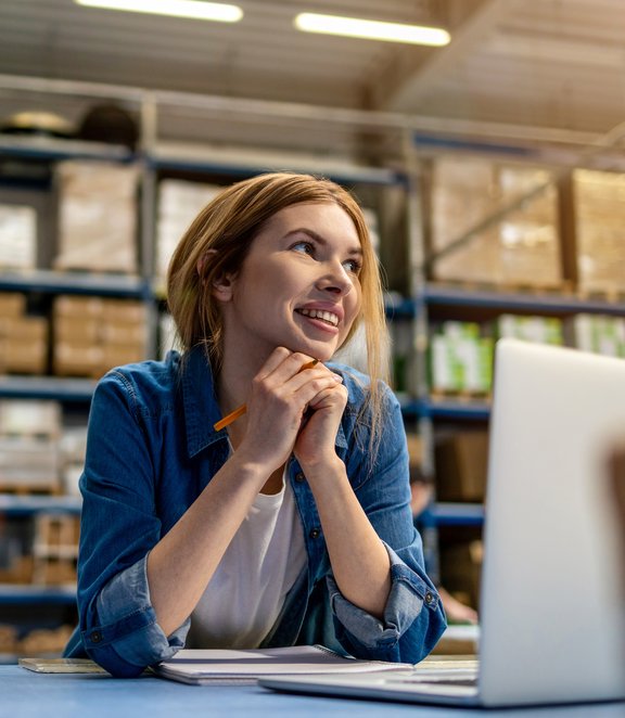 Woman working on her laptop in a sorting center