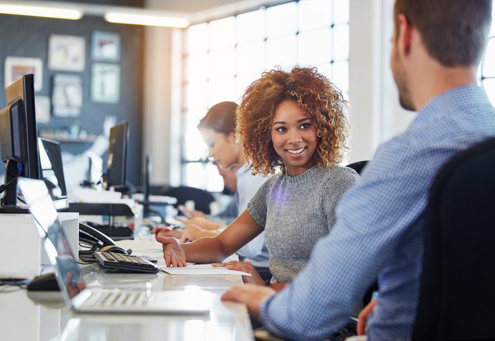 woman at office desk with laptop